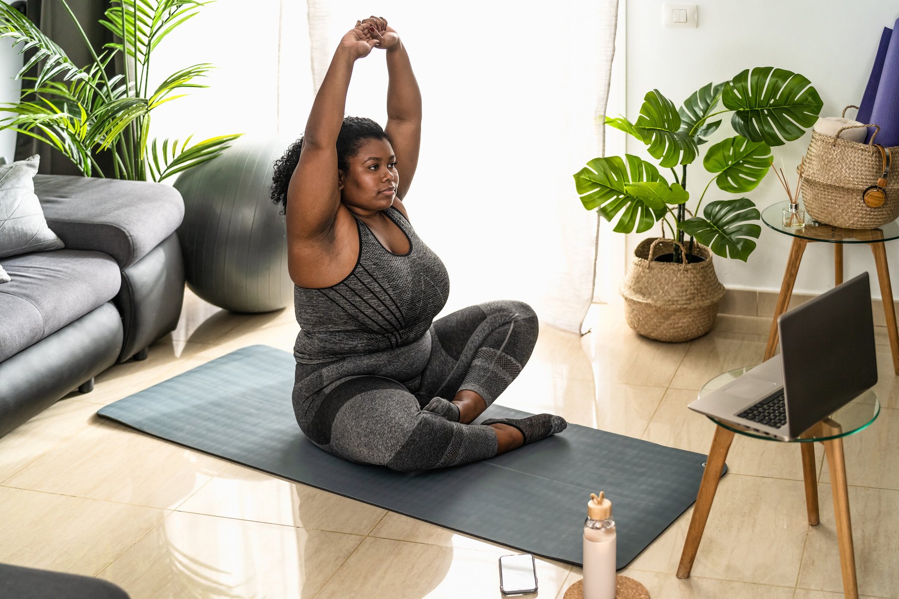 Woman Doing Pilates Online Fitness Class at Home